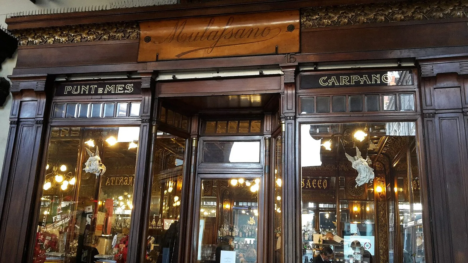 La vetrina in legno di un caffè storico sotto i portici di Torino